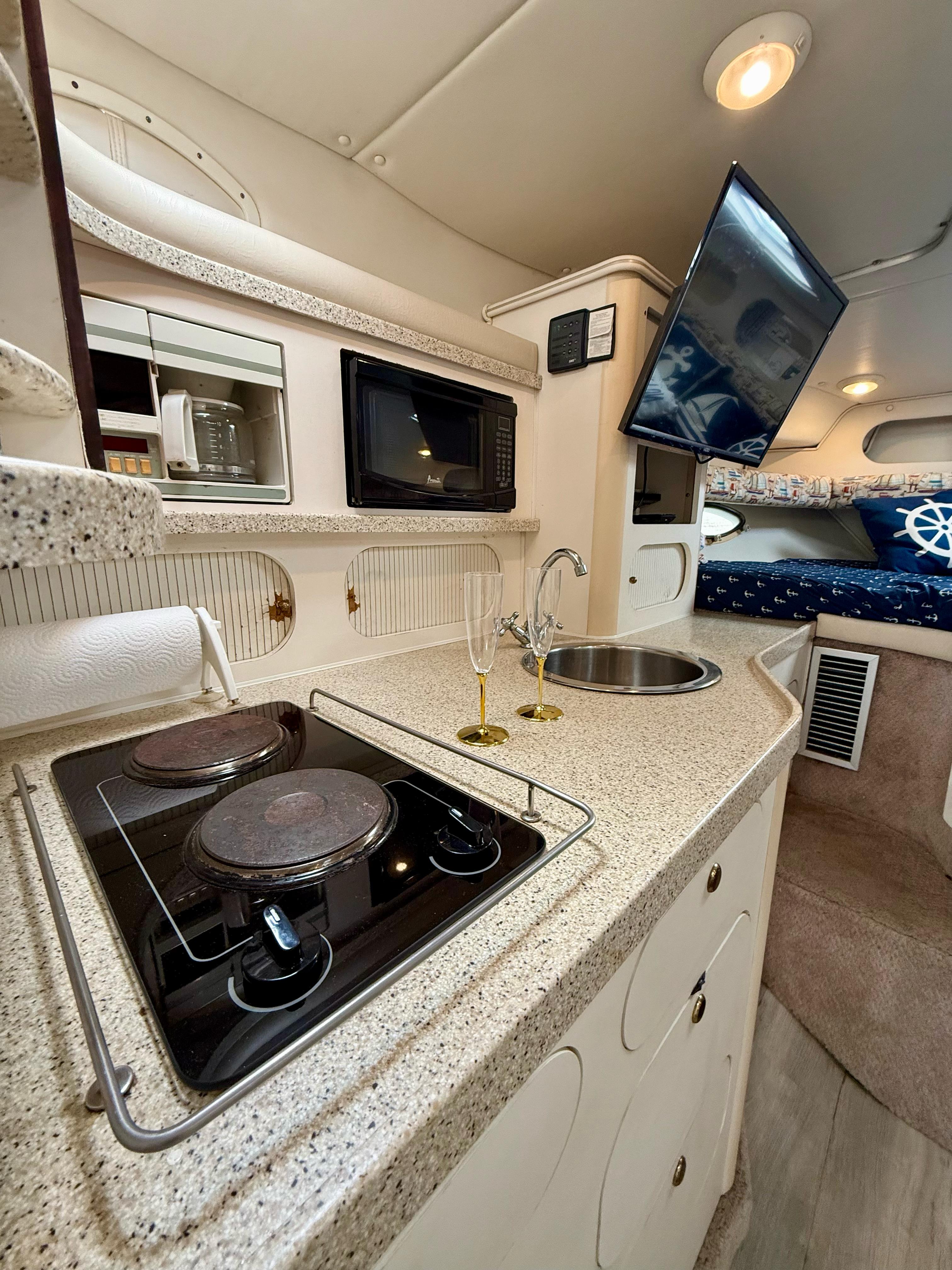 Boat kitchen with stove and TV